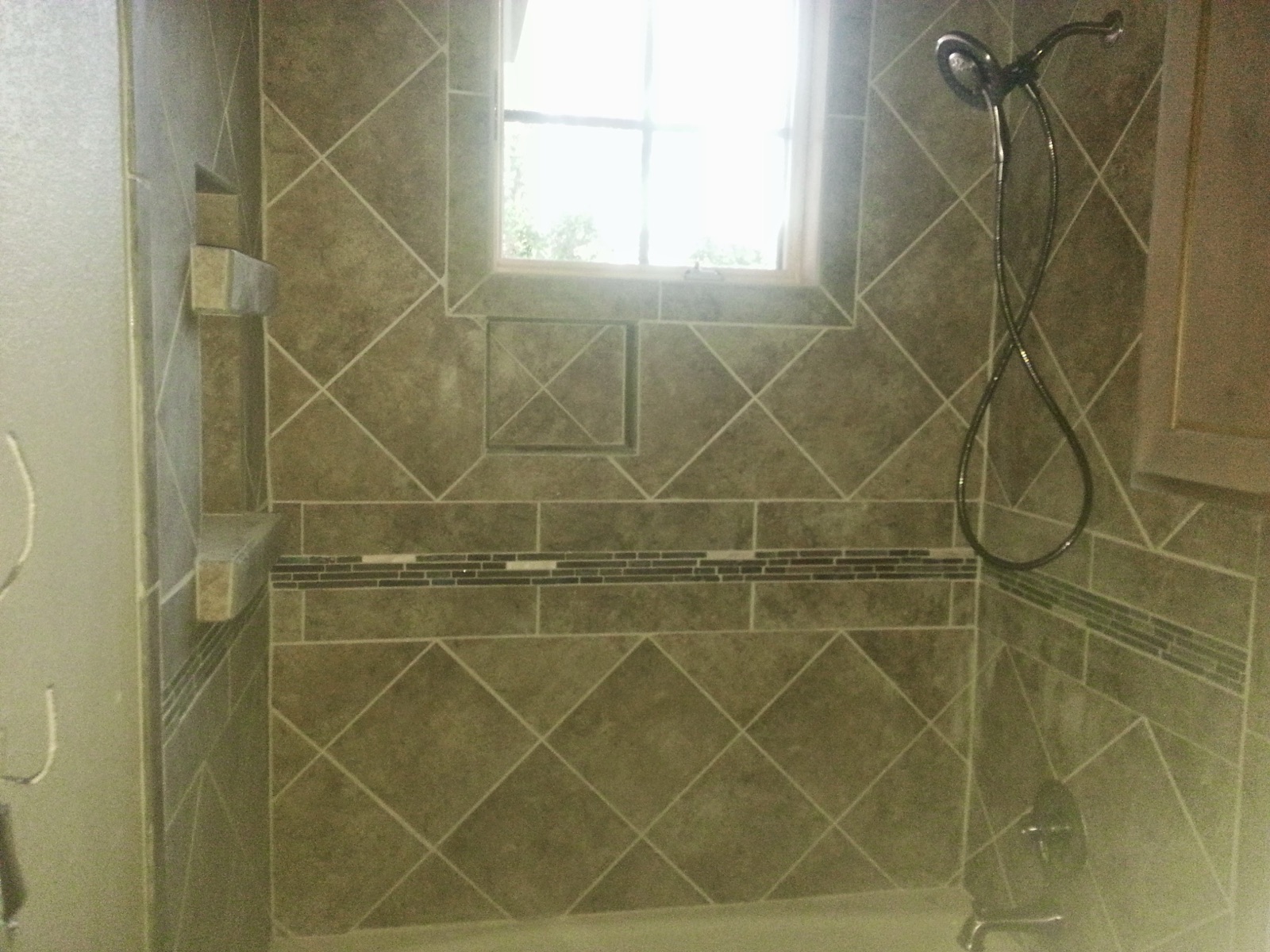 Custom diagonal tile shower with window